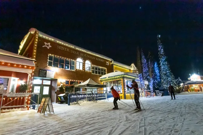 Cross-country skiing through SilverStar village at night
