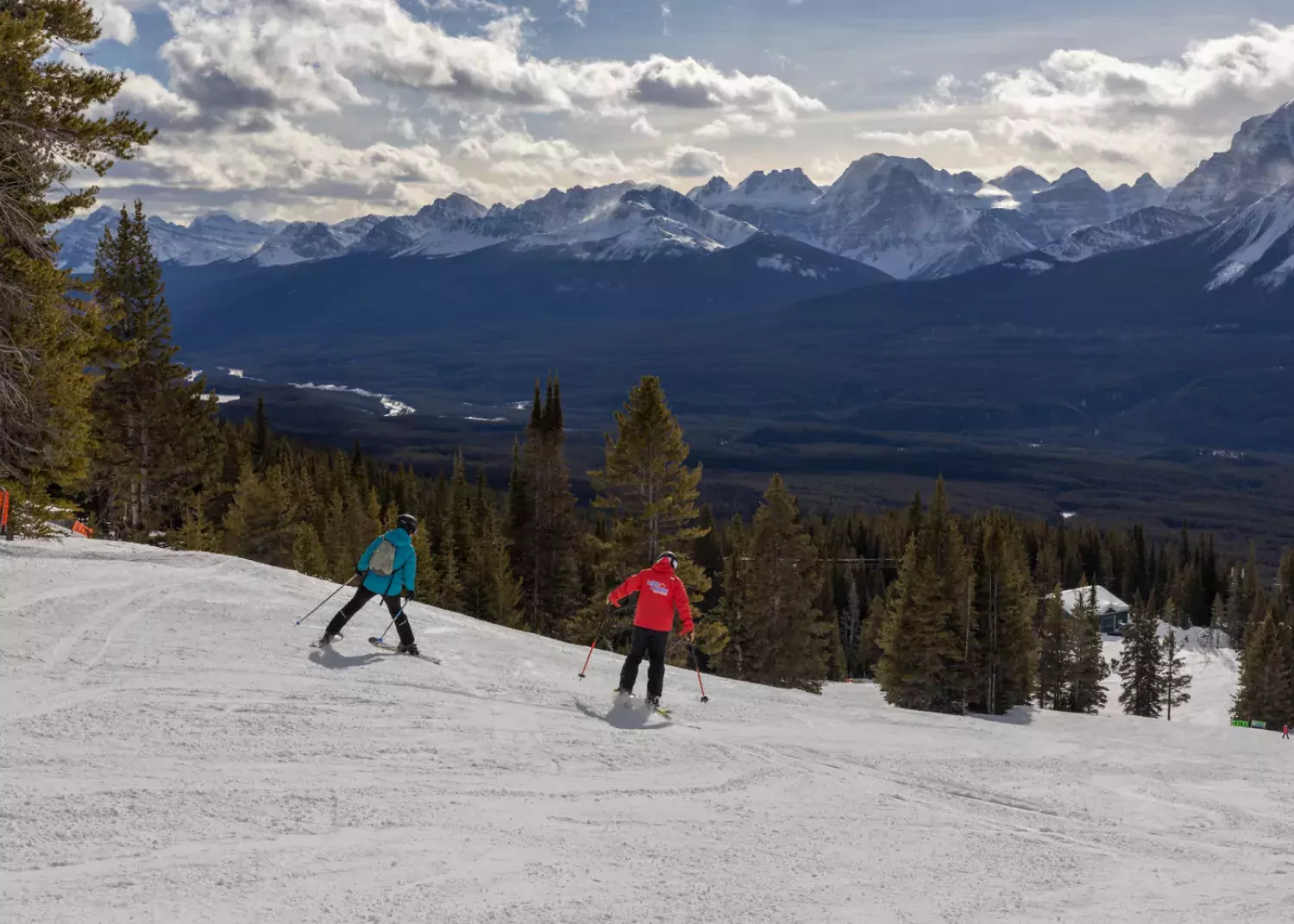 Tina Bels and instructor Kyle Armstrong cruise the slopes at Lake Louise. / Paul Lavoie park ski lesson Lake Louise Ski Resort AB