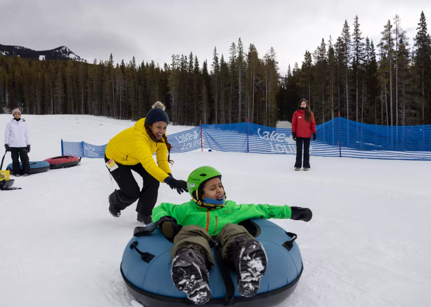 Snow tubing after a ski lesson. / Paul Lavoie snow tubing Lake Louise Ski Resort AB