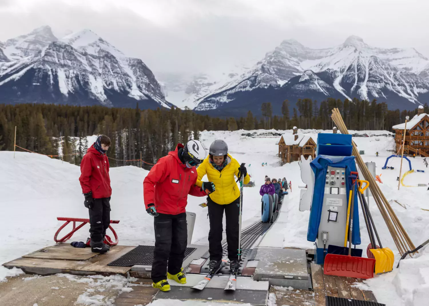 Offloading the magic carpet at Lake Louise, with the help of an instructor. / Paul Lavoie magic carpet Lake Louise Ski Resort beginner area, Alberta
