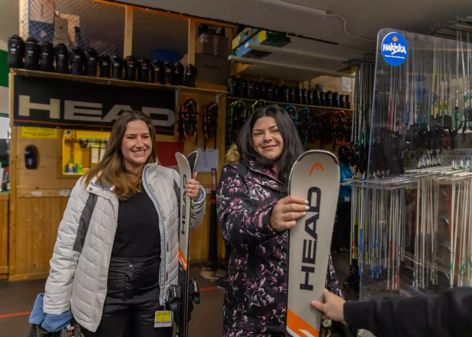 Friends rent skis at Nakiska Ski Area in Kananaskis, AB