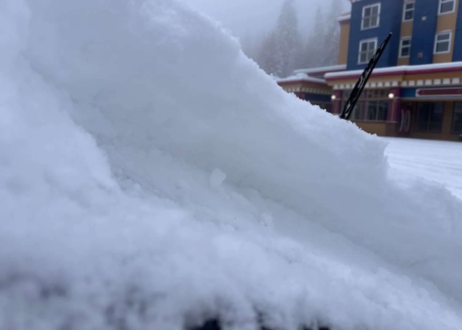 Brushing snow off the windshield at SilverStar